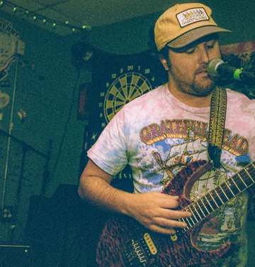 TaxFraud's singer and guitarist mid-song in a Grateful Dead shirt